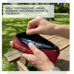 Red pouch with blue pen held by a hand outdoors 