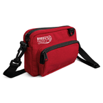 Red bag with black straps on a white background, featuring 'Breezy Packs' branding. 